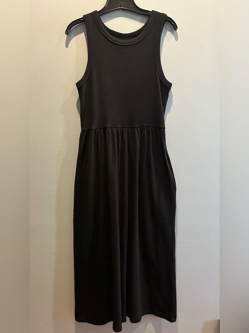 Black Sleeveless Midi Dress with Gathered Waist and side pockets.